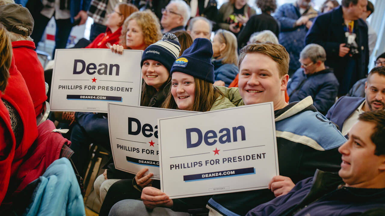 Quinnipiac students holding signs