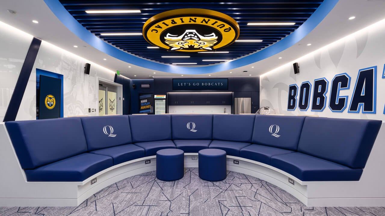 The entire couch and memorabilia inside the women's ice hockey locker room.
