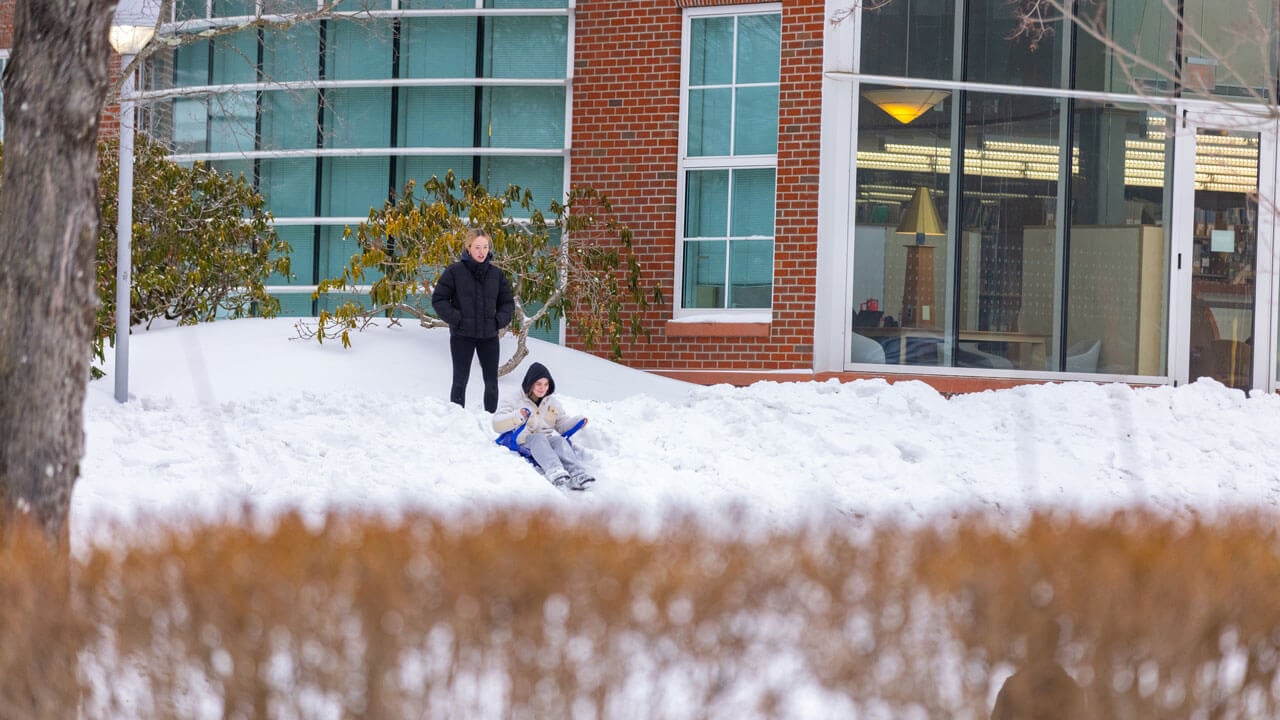 Students go sledding on the quad