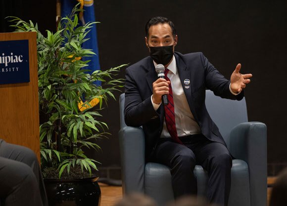 Julian Castro sitting on chair and speaking to students at event