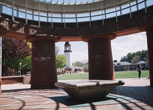The Arnold Bernhard Library is seen through the Lender School of Business Center dome