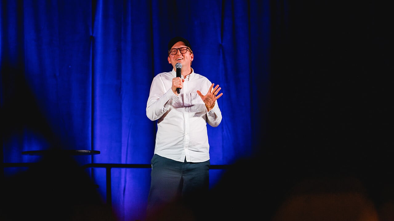 James Austin Johnson gestures during a joke.