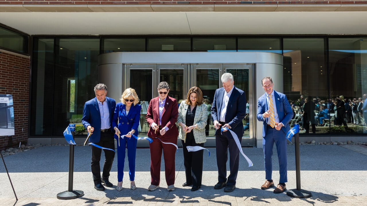 Group cuts a ribbon