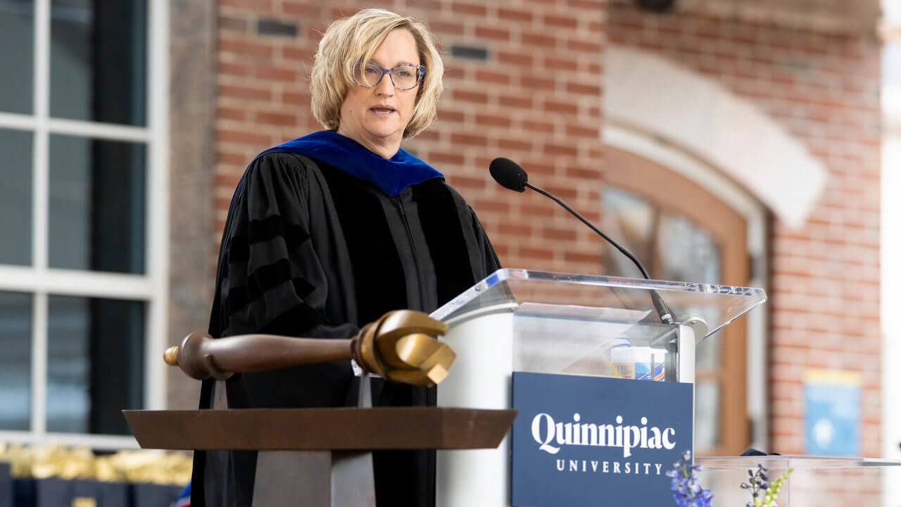 Sonja LaBarbera speaks to students from podium at commencement ceremony