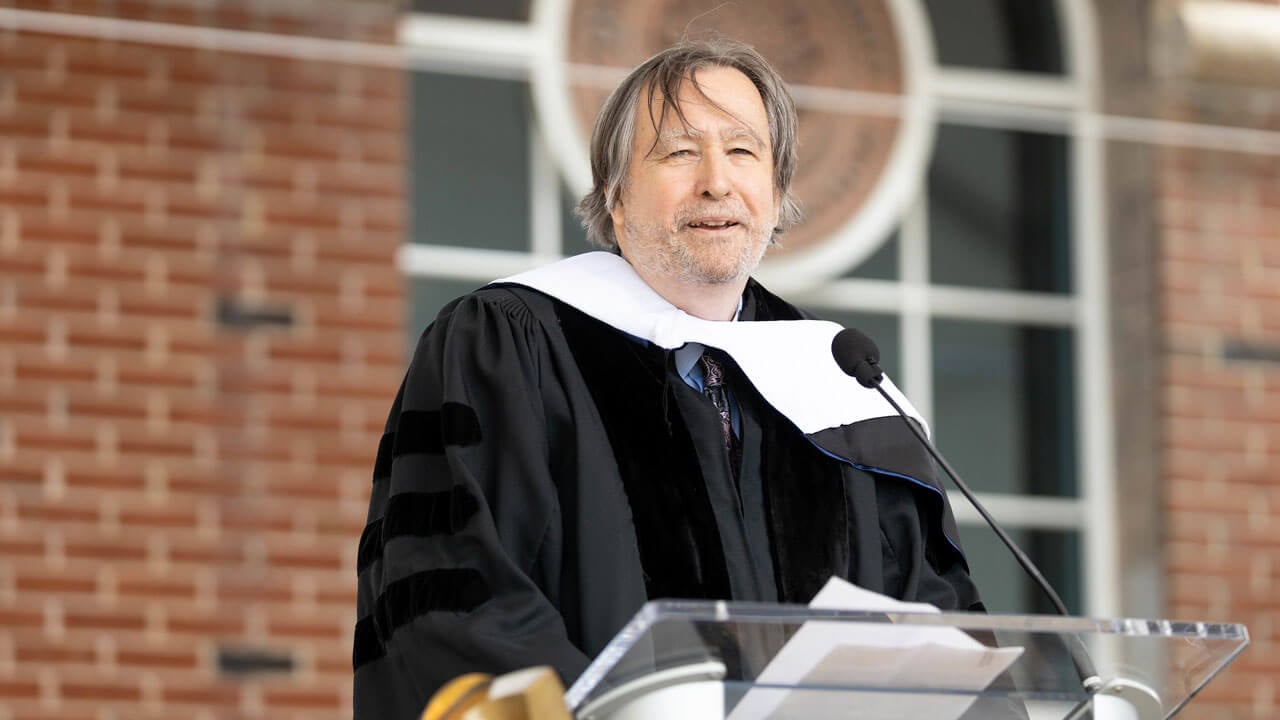 Cheyney Ryan speaks at the podium during Commencement