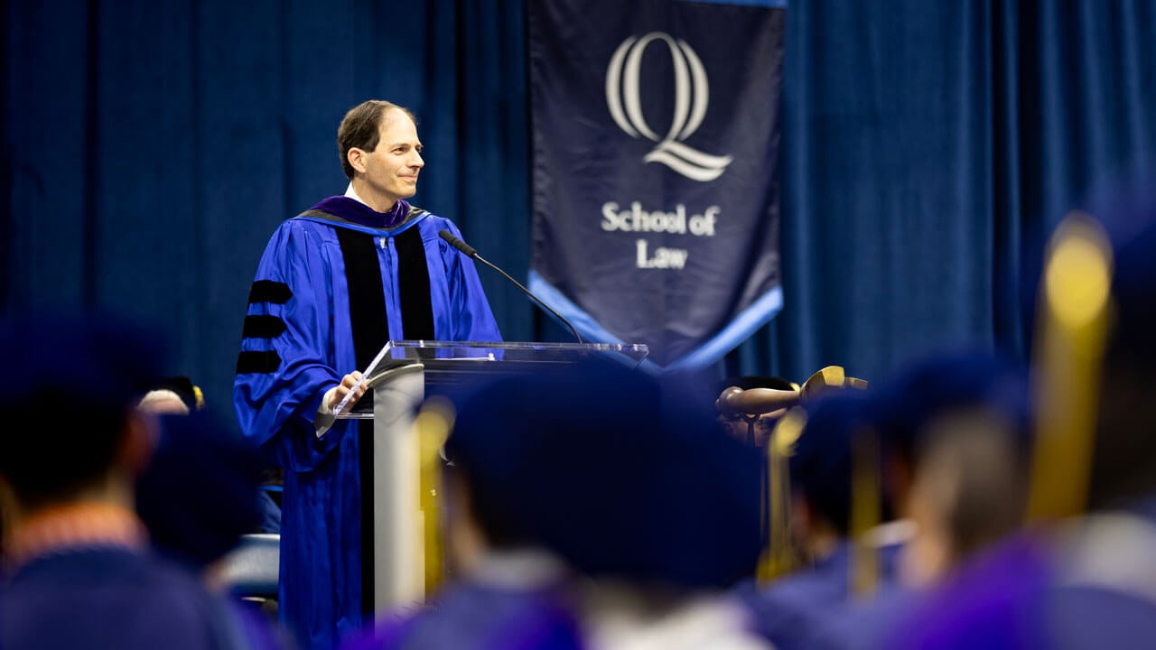 Professor of the Year, Jeffrey Cooper, addresses graduates from the stage.
