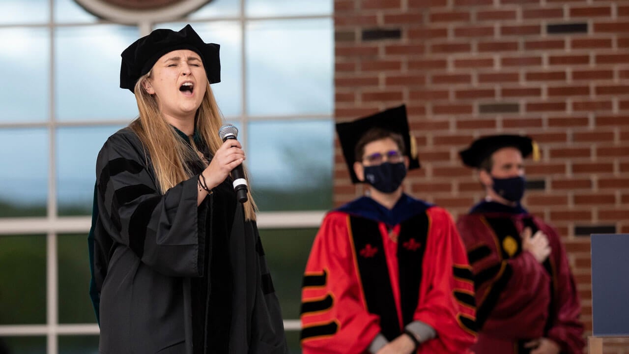 Caroline Ringle sings from the library steps