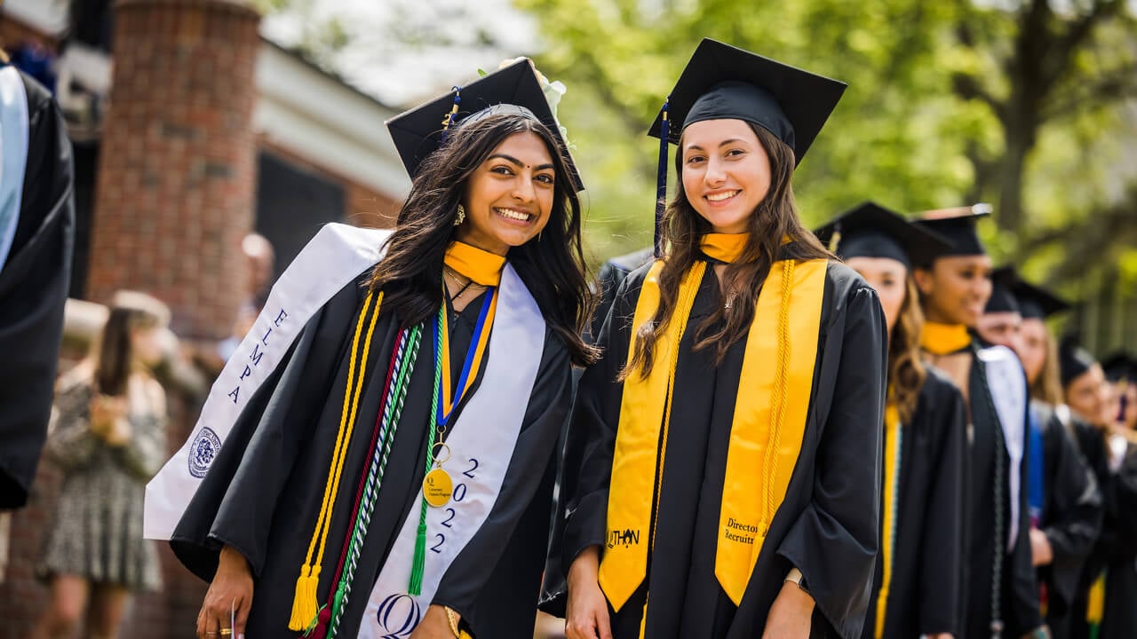Two graduates smile together
