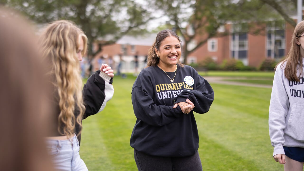 Student smiles in their orientation group