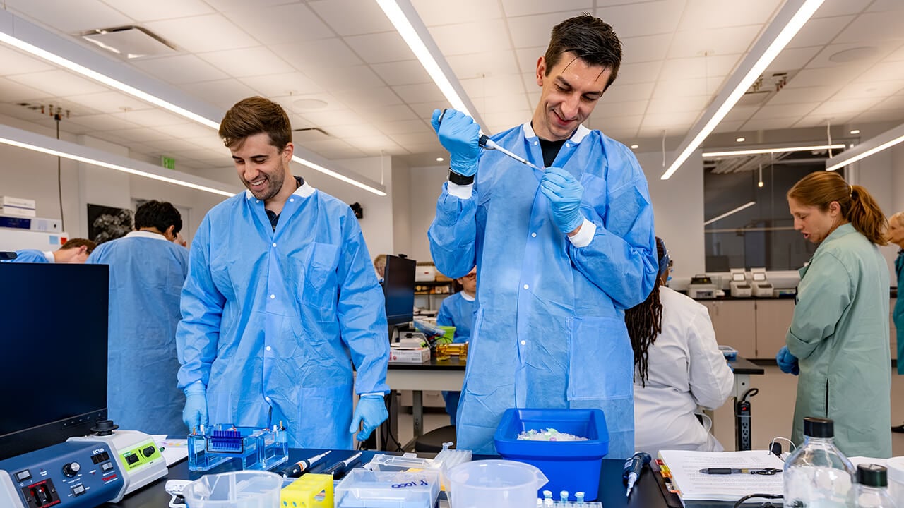 Lab participants pipetting into tubes