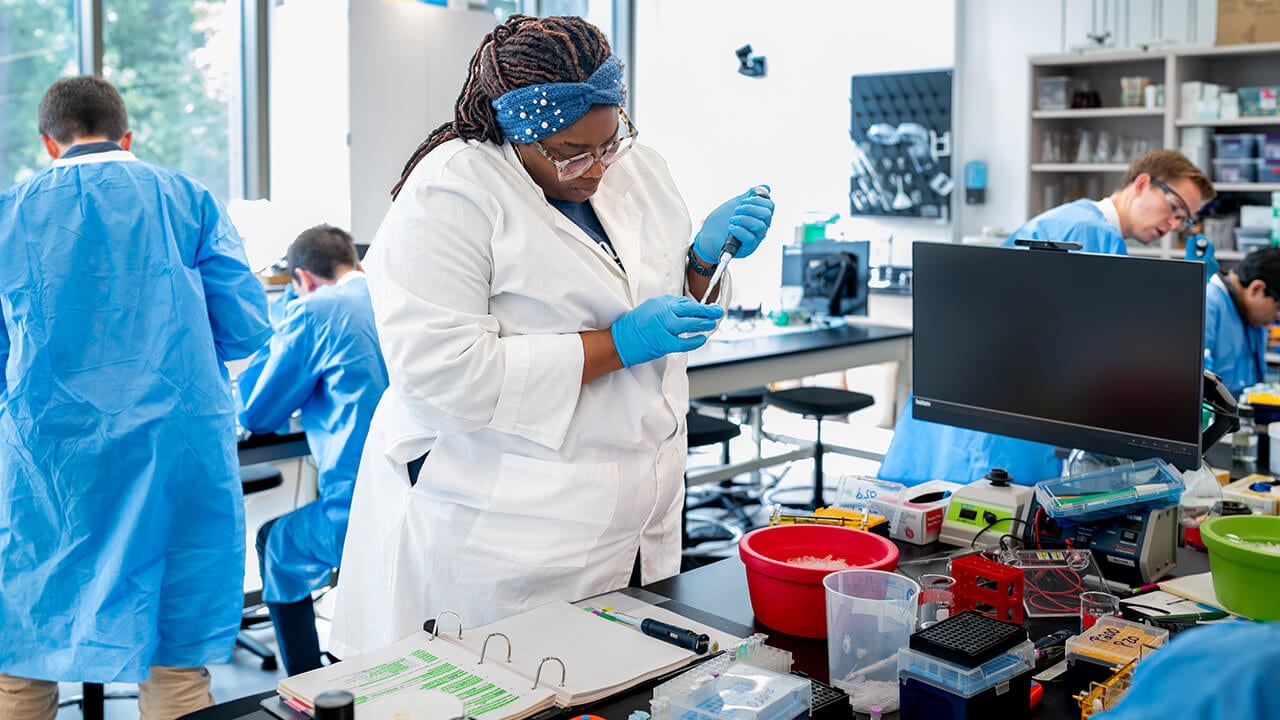 Workshop participant pipetting into small tube