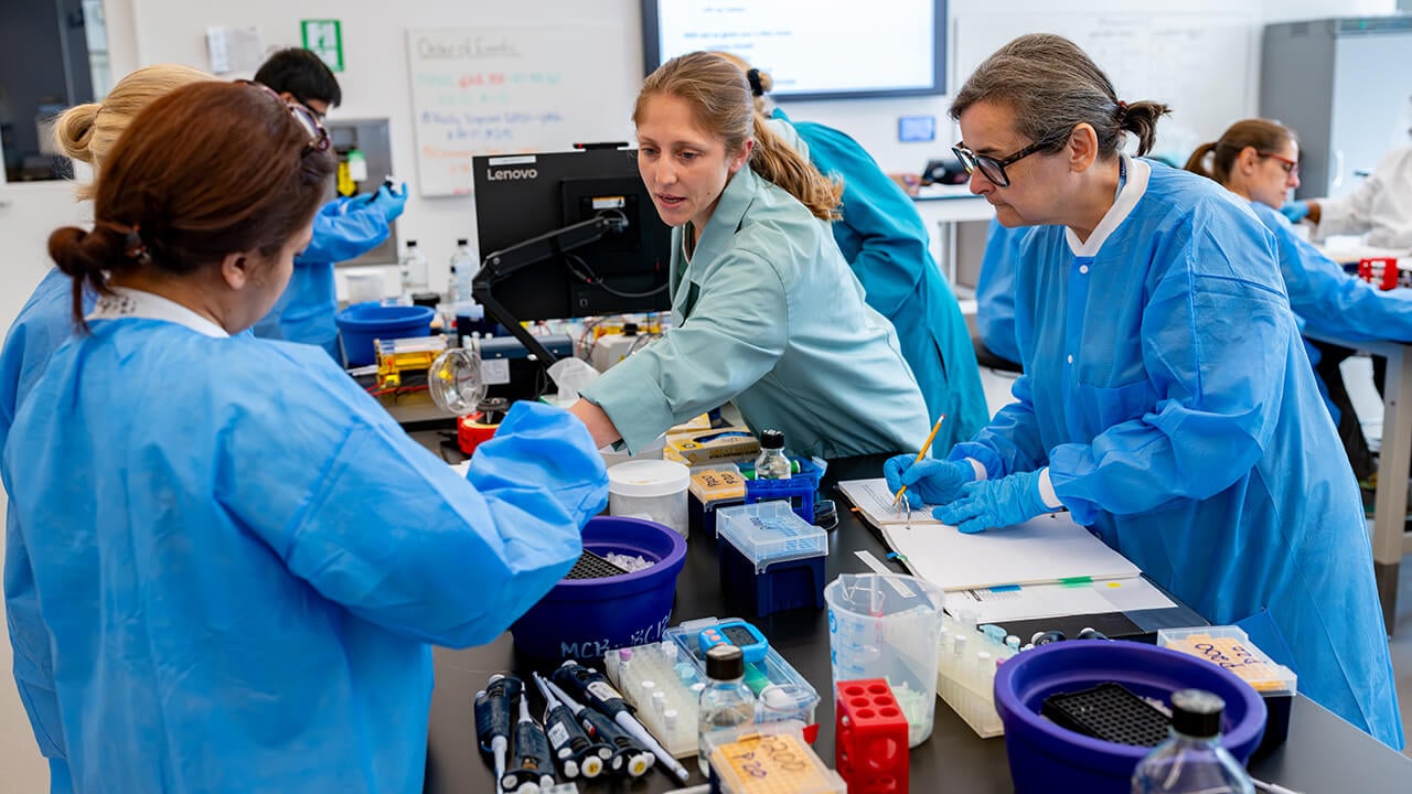 Workshop instructor pointing to lab equipment