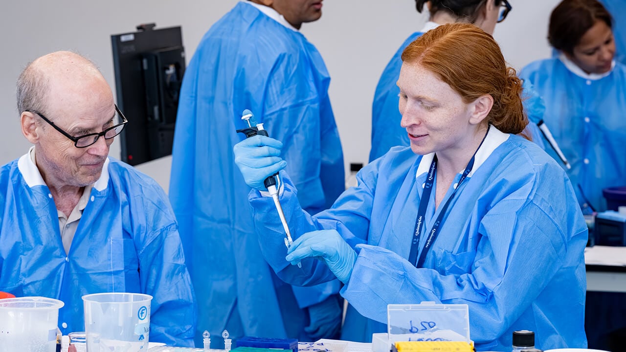 Pair of workshop participants pipetting substances
