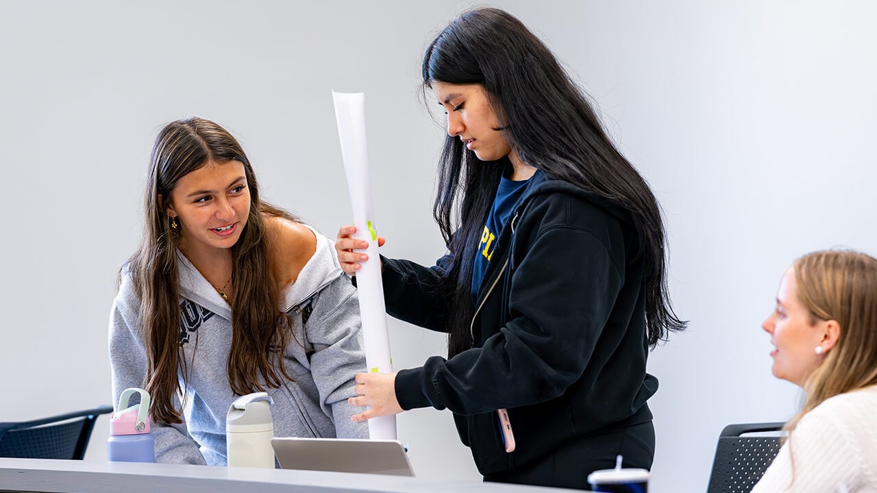 Students building a paper tower