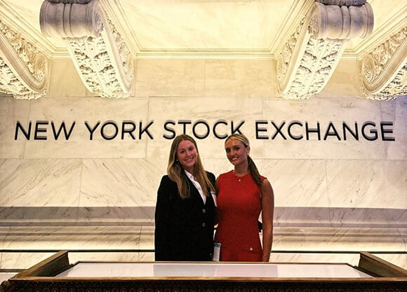 Caroline Matyczyk '26, MBA '27 at New York Stock Exchange with a coworker.