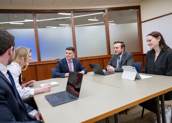 Brendan Holt sitting with students
