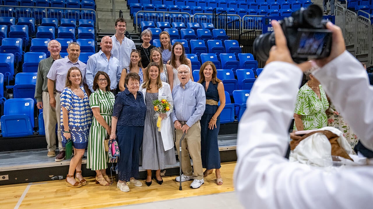 Student taking a photo with family