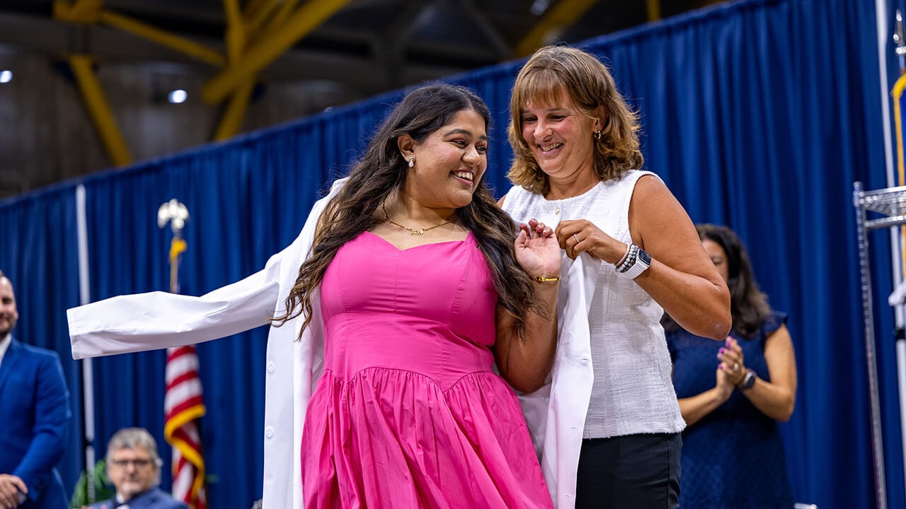 Student presented with white coat