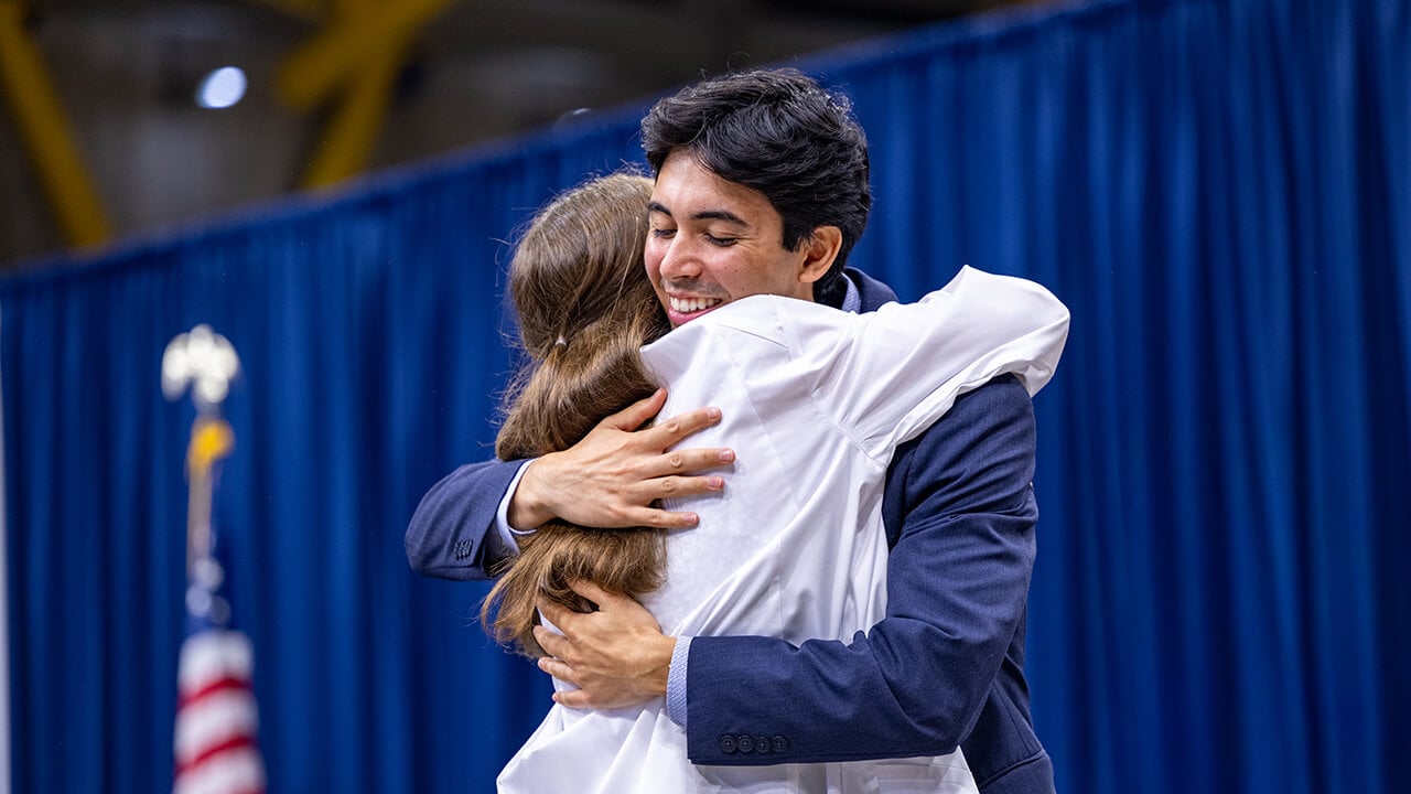 Student and family member hugging