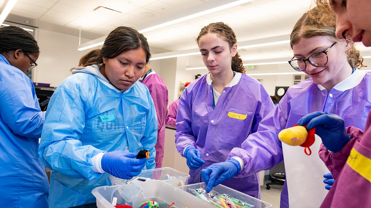 Student gathered around lab bench