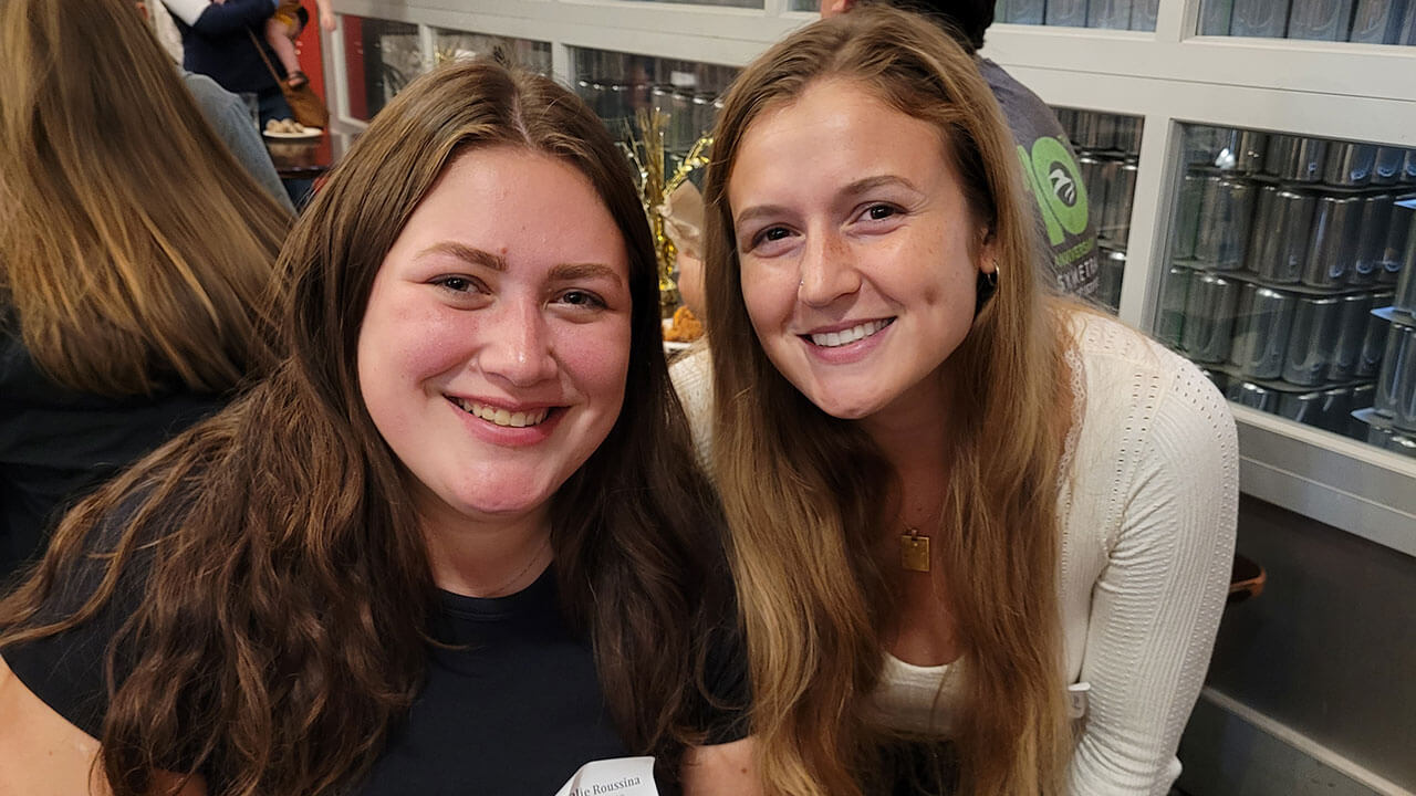 Two alumnae enjoy each other's company at the alumni happy hour in Boston