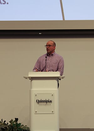 Stefano Fasulo speaking at the podium