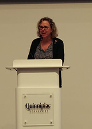Liz Brown standing at the Quinnipiac podium