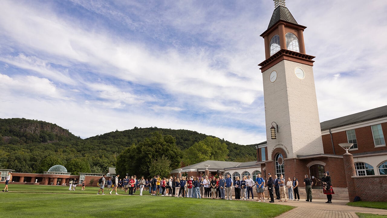 University community standing in front of the Arnold Bernhard Library