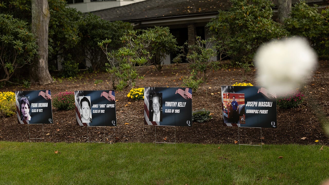 Signs honoring the four university community members who lost their lives on 9/11