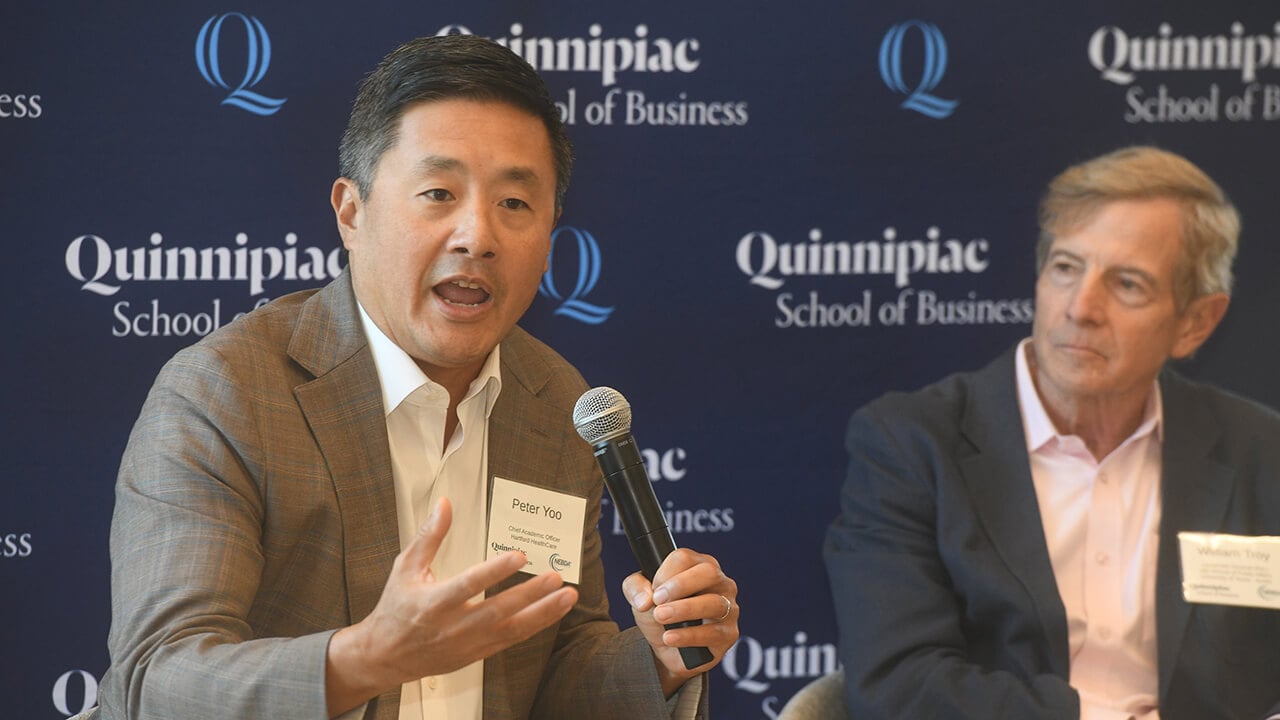Peter Yoo speaks into microphone