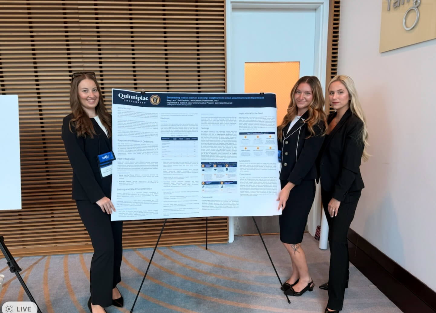 Kali Kapilotis, Mary Lech and Kimberly Przeszlowski pose next to their poster project