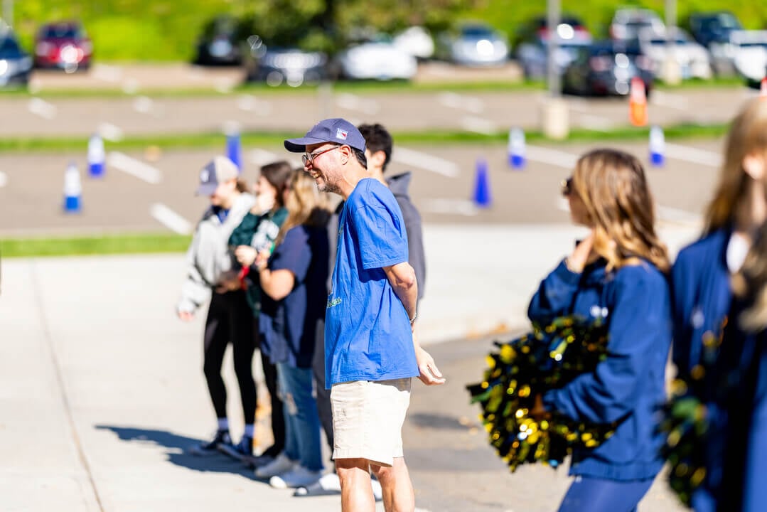 Man smiles as he listens to live band on Bobcat Weekend
