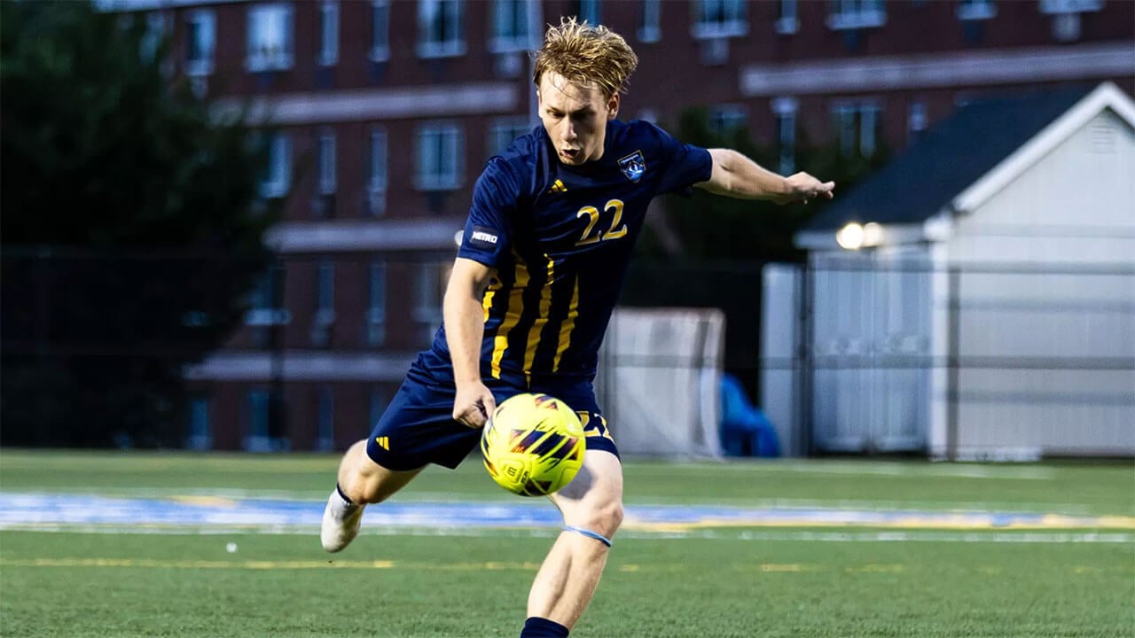 Soccer player kicks ball.