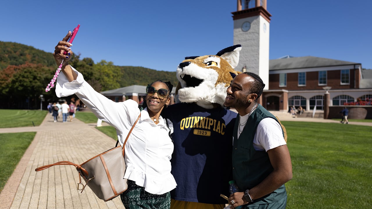 Two people taking a selfie with Boomer.