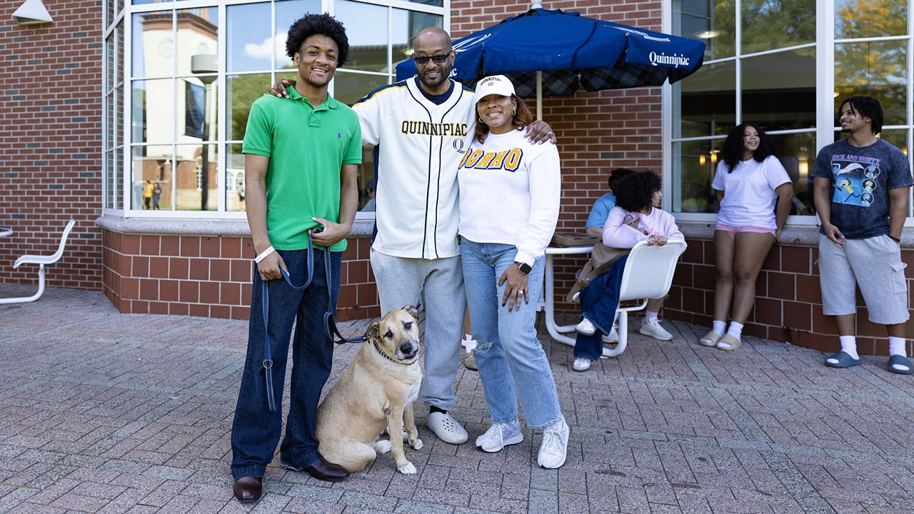 A family with a dog.