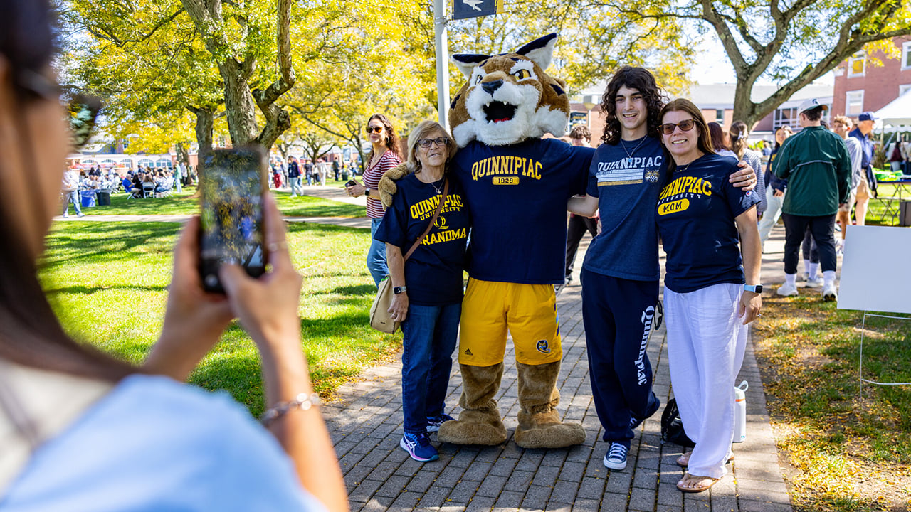 A family taking a photo with Boomer.