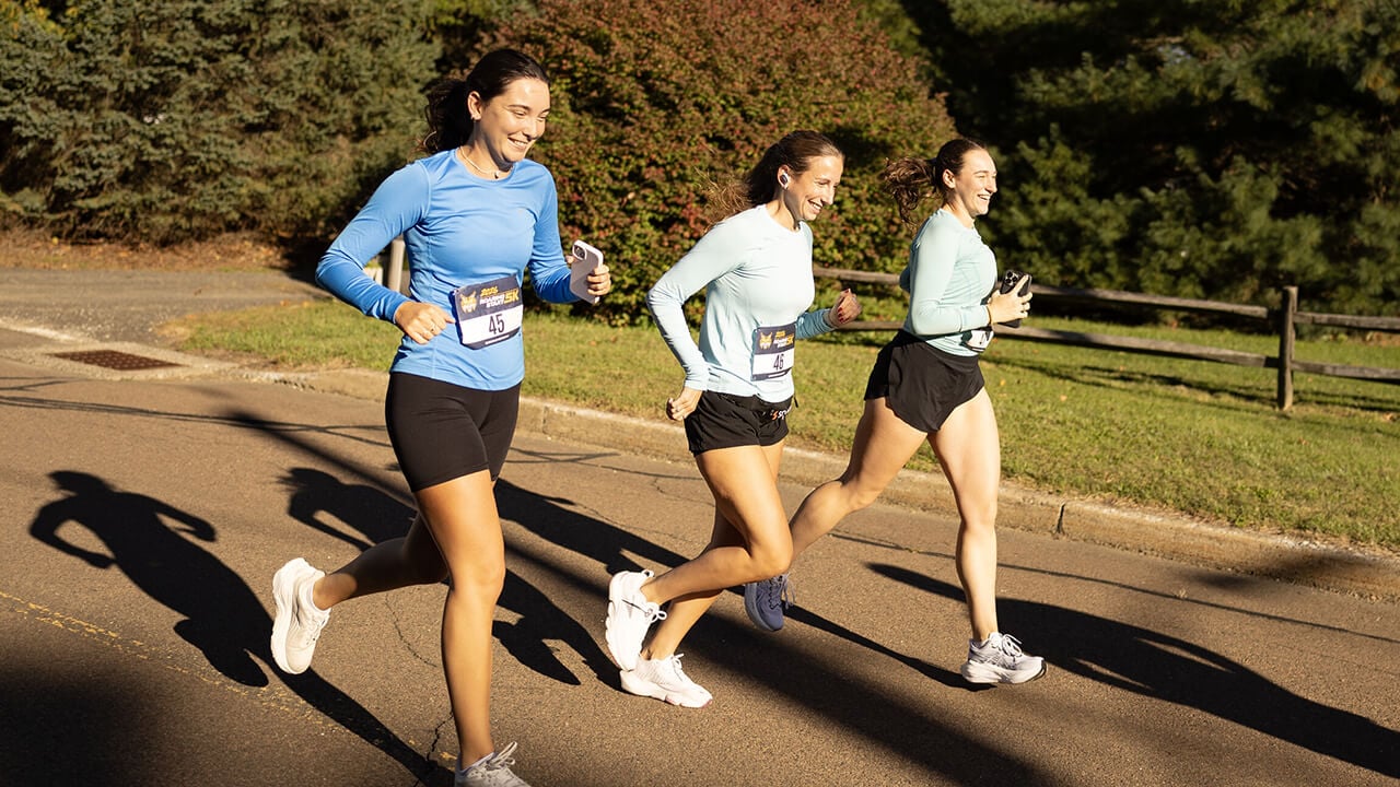 A group of three people running together.