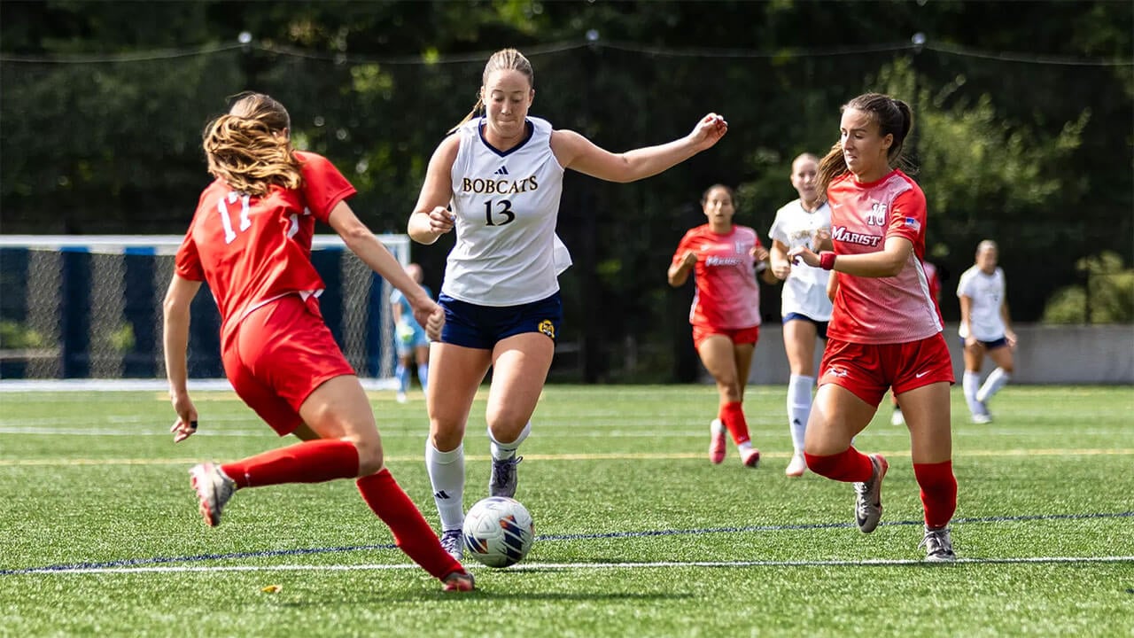 Quinnipiac soccer player steals ball from another team.