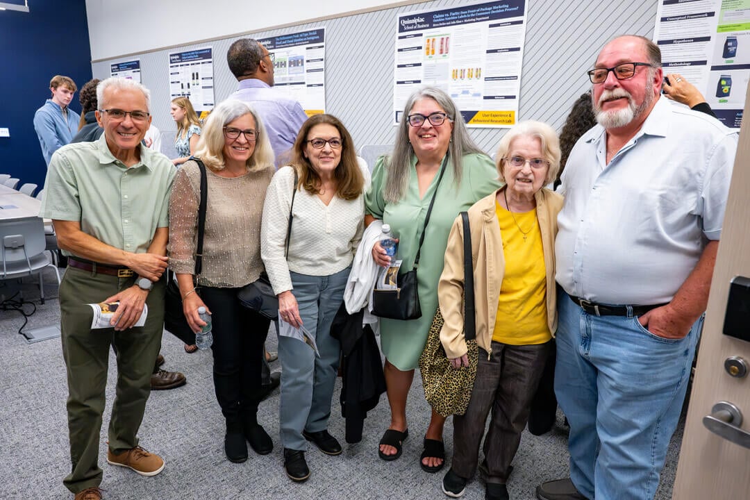 Family poses inside Behavior Lab during dedication ceremony.