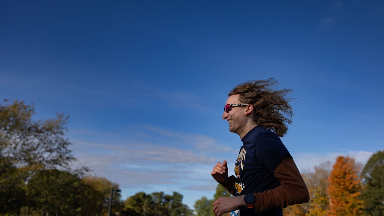 Runner racing with a smile on their face