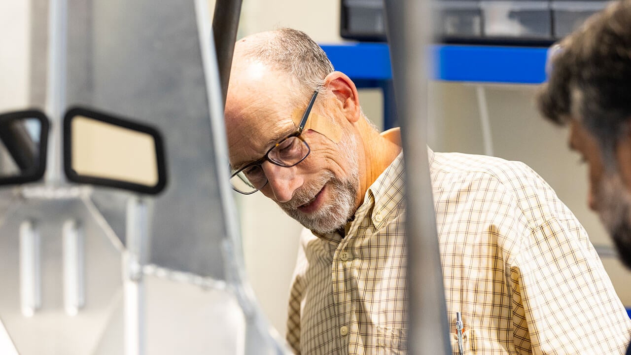 Man stands behind engineering equiptment
