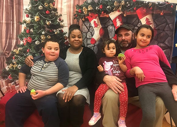 Scott family in front of Christmas decorations