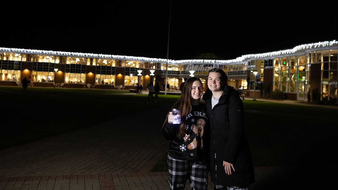 Students smile in front of the Student Center