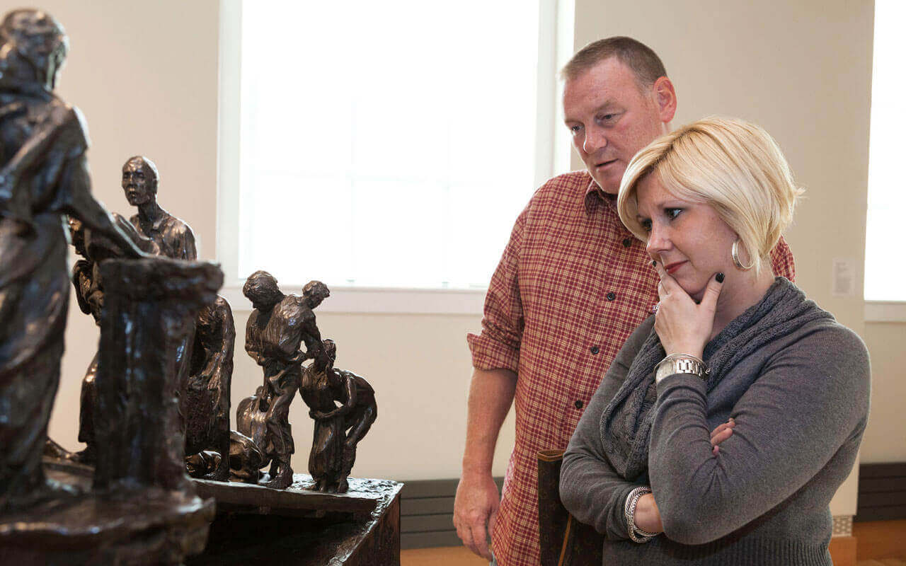 Man and woman looking at statues