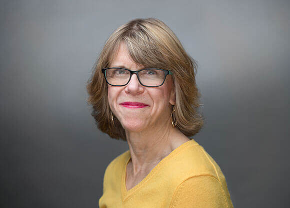 Nursing Professor Sheila Molony in a gold shirt.